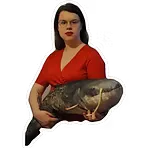 The artist holding a large plushy catfish.